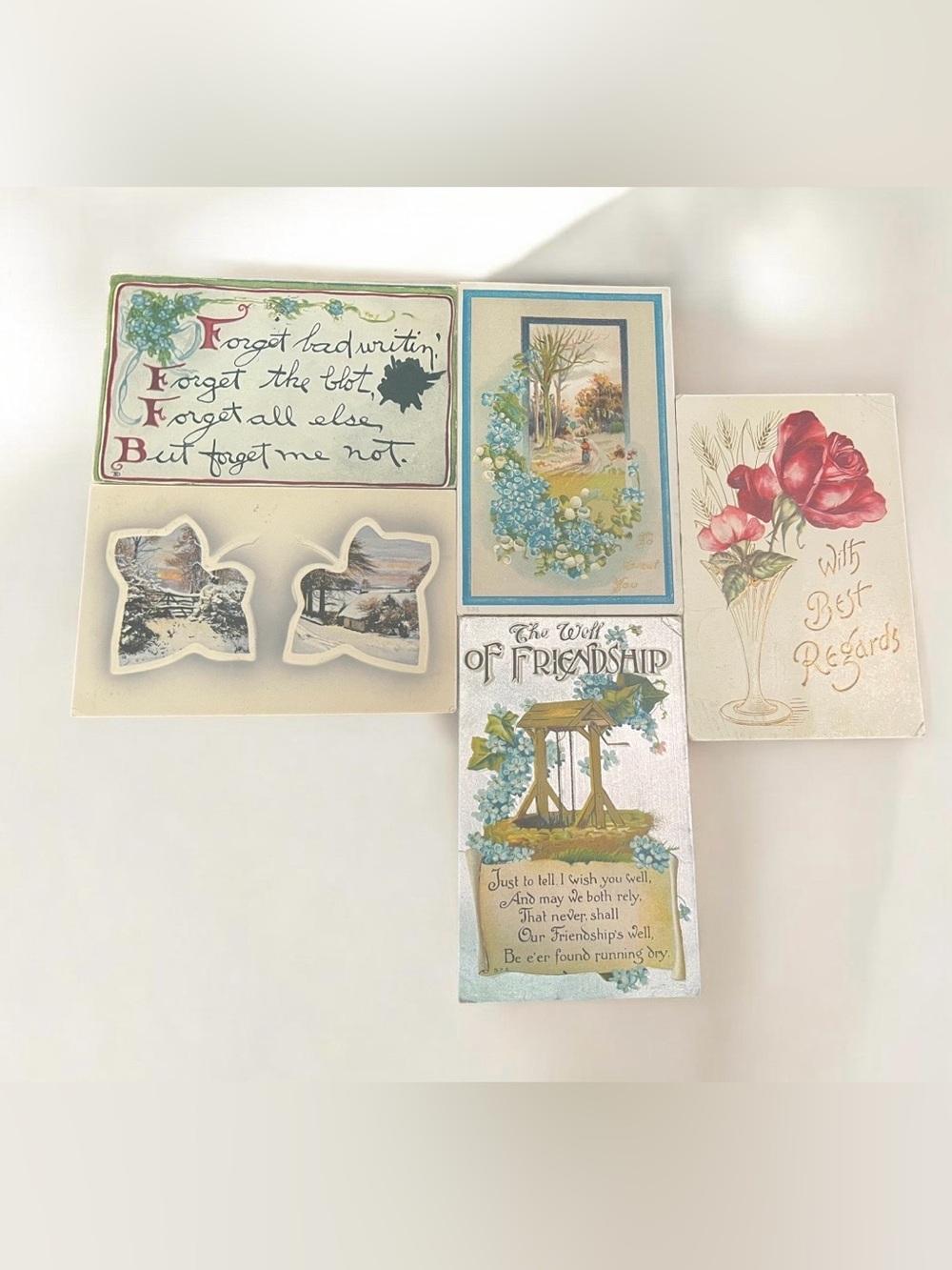 A collection of five vintage postcards with various sentiments and illustrations